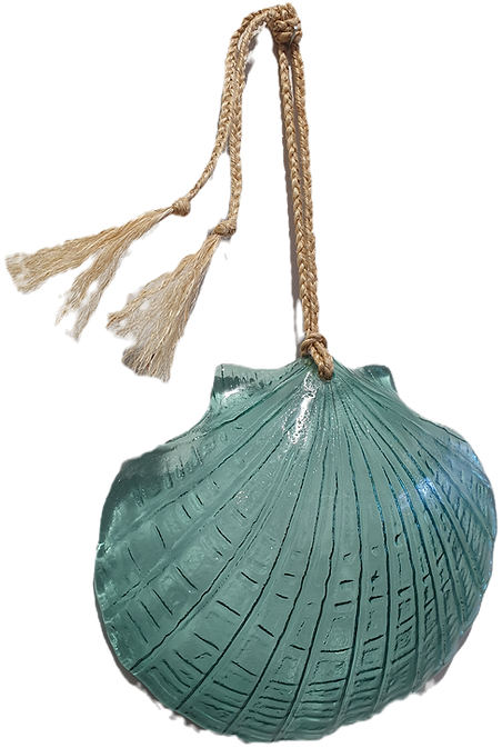 A green fused glass wall hanging in the shape of a scallop