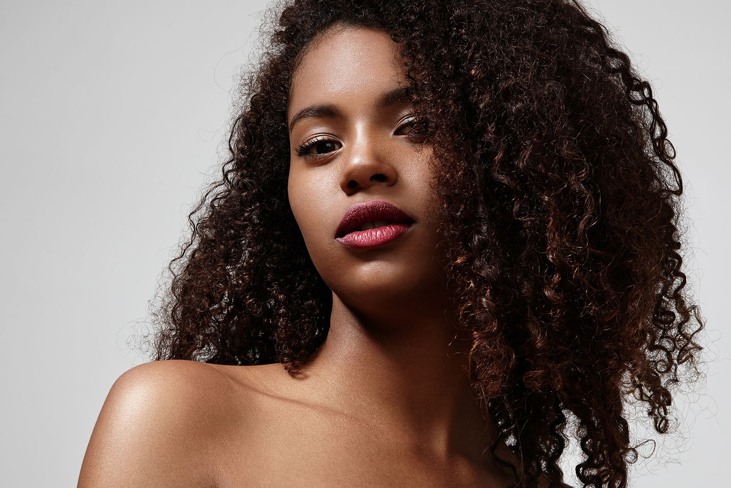 Pretty Black Woman With A Bright Lipstick And Curly Hair.jpg