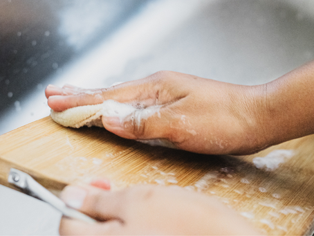 Person cleaning a cutting board