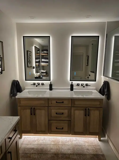 Modern bathroom with illuminated mirrors and vanity
