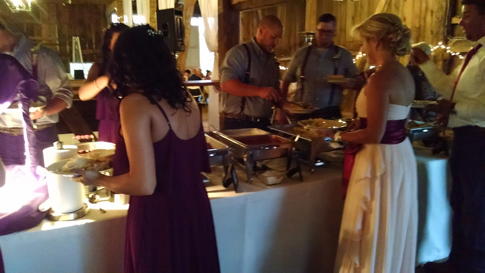 Elegant wedding reception table with gourmet dishes and floral centerpieces, showcasing upscale catering in Pittsburgh