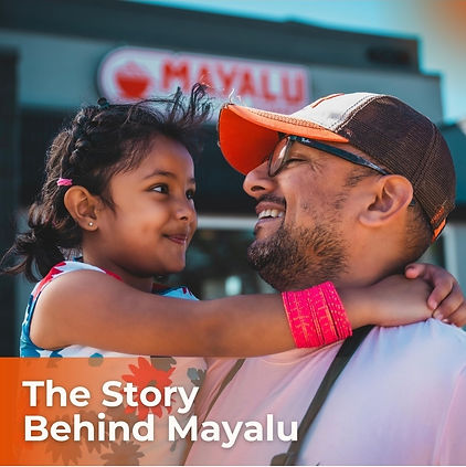 A father and daughter smile lovingly in front of Mayalu restaurant