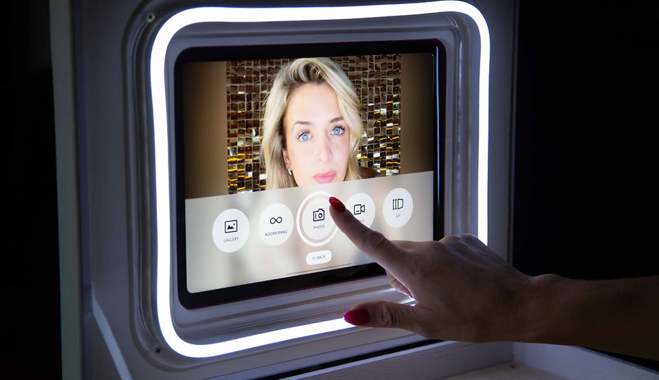 a woman using booth in a box photo booth
