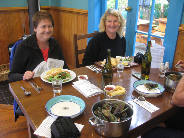 Two people dining with seafood and wine.