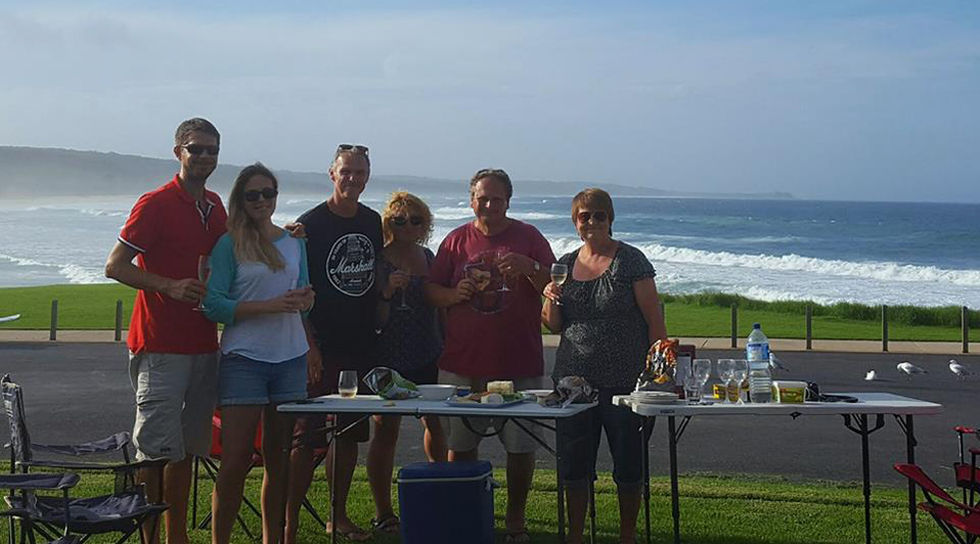 Group enjoying outdoor gathering by the ocean.