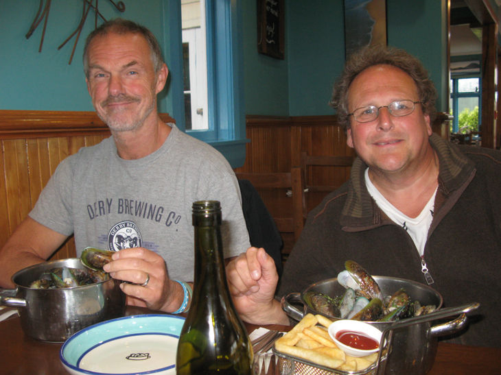 Two people enjoying a meal with drinks.