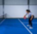 A girl playing pickleball