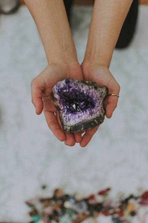 Two hands holding an ethically sourced amethyst geode.