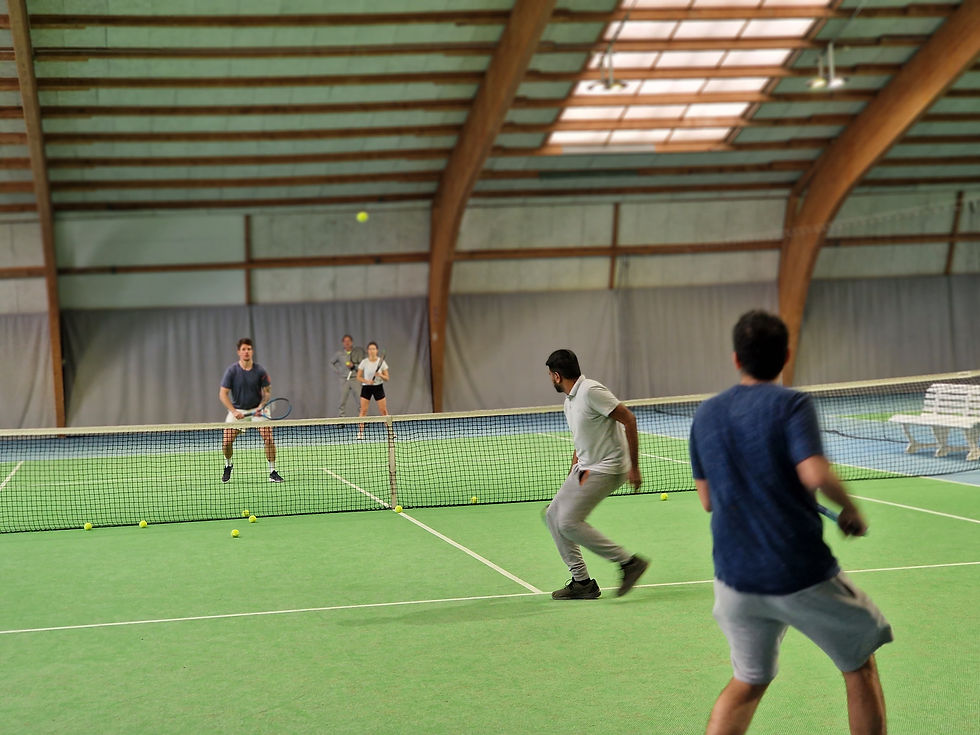 Players playing a doubles tennis match