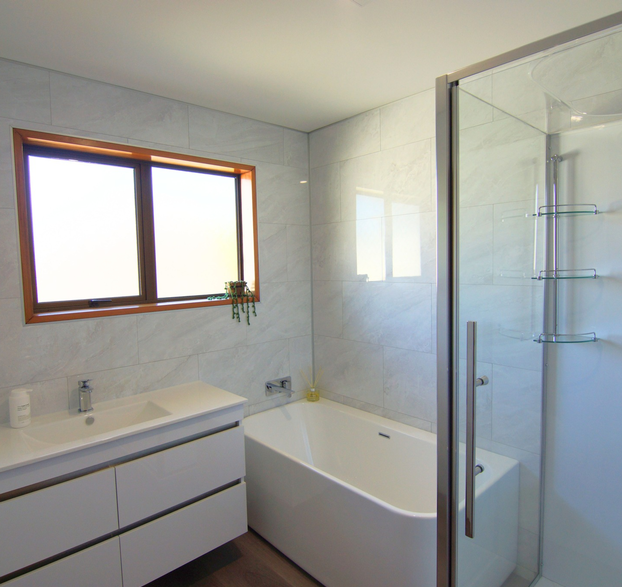 Modern bathroom renovation with walk-in shower and tub