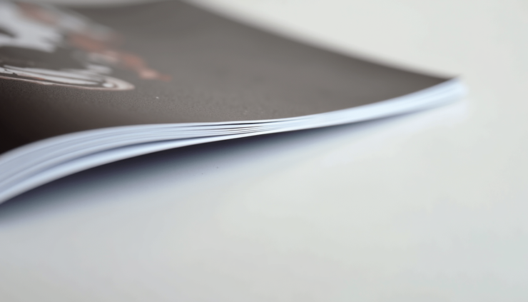 Close-up view of a printed brochure showing bleed and crop marks along the edges