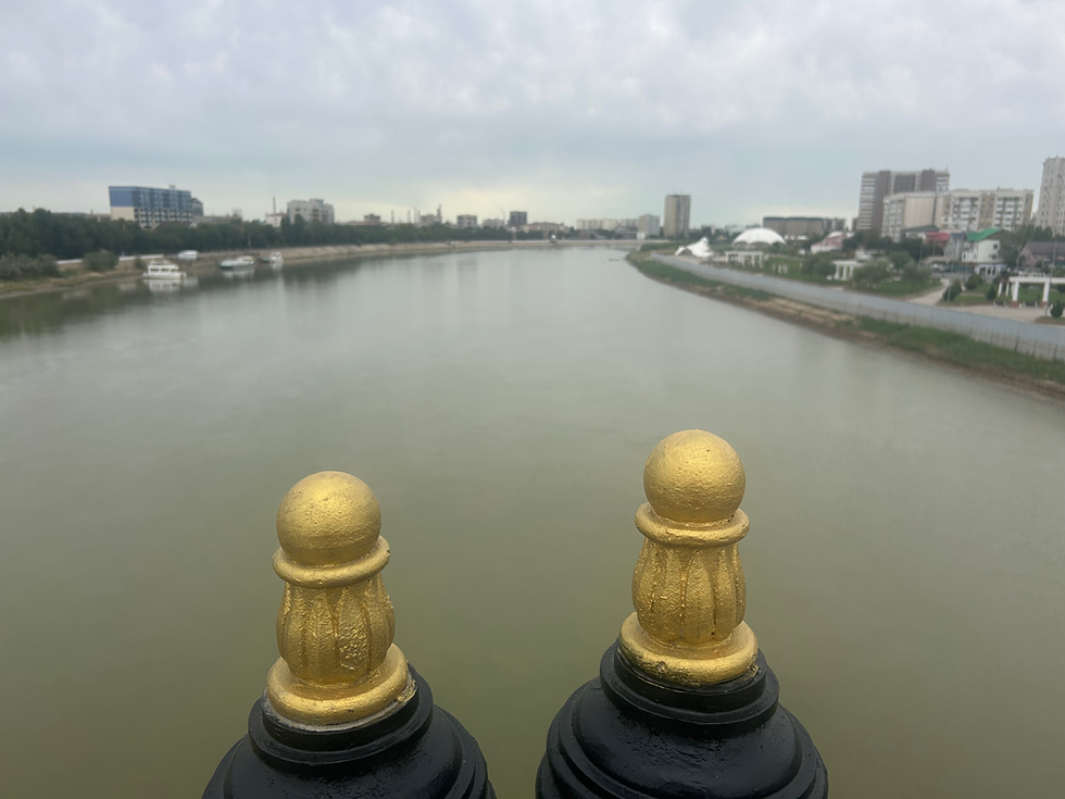 In the center of the bridge over the Ural river in Atyrau, connecting Europe with Asia