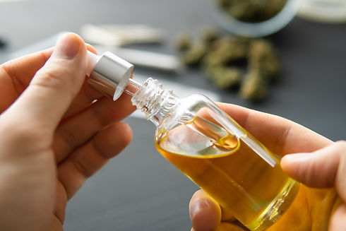 cbd oil gold hands.jpeg