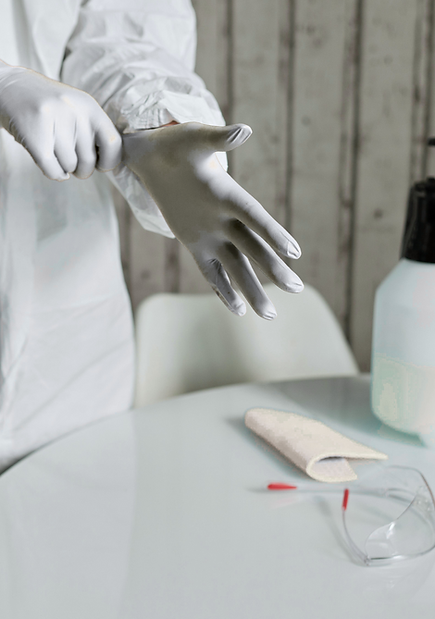 Closeup of Biohazard professional putting on gloves