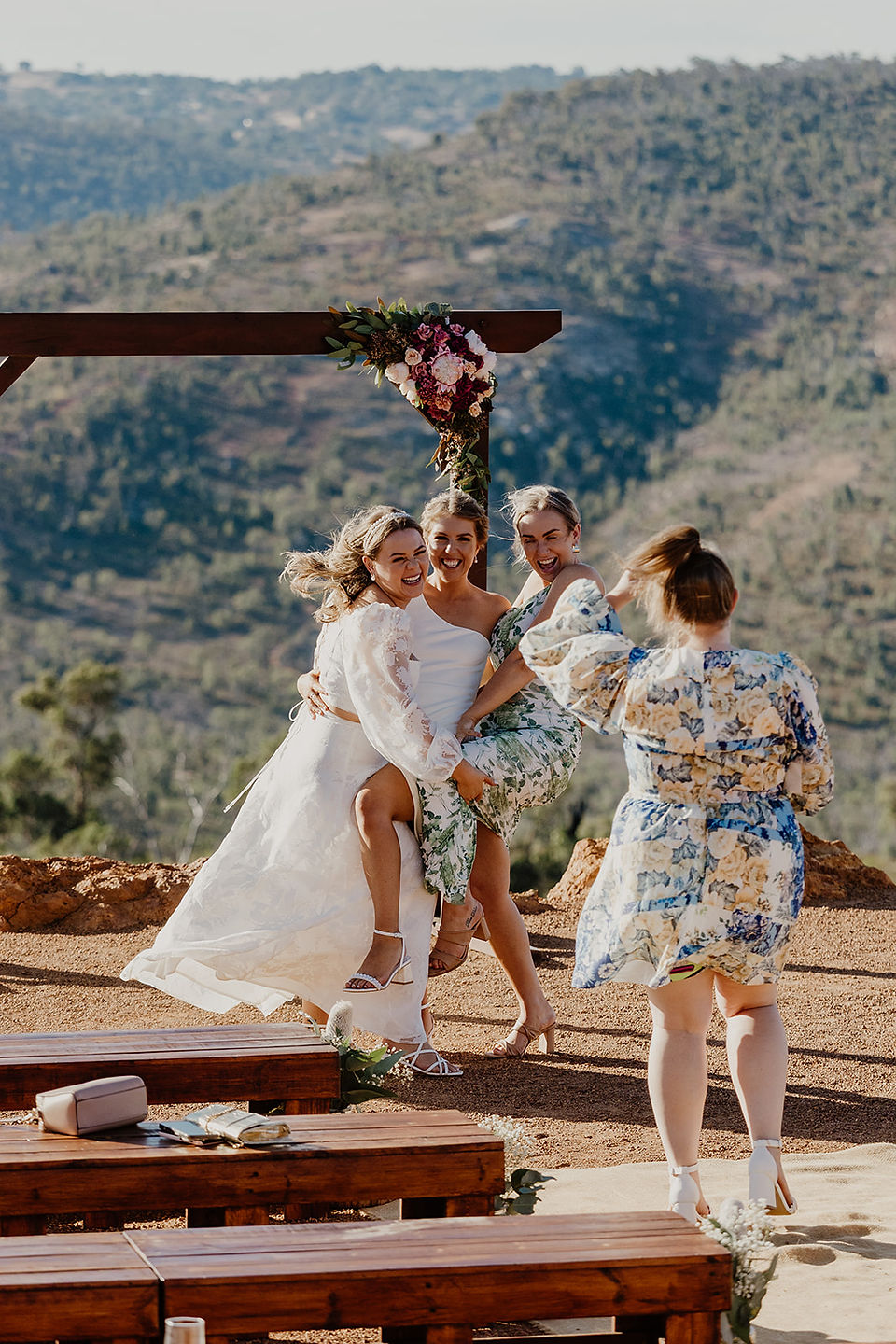 Two brides laugh and pose for a photo with their friend at Anderson Point Perth Hills