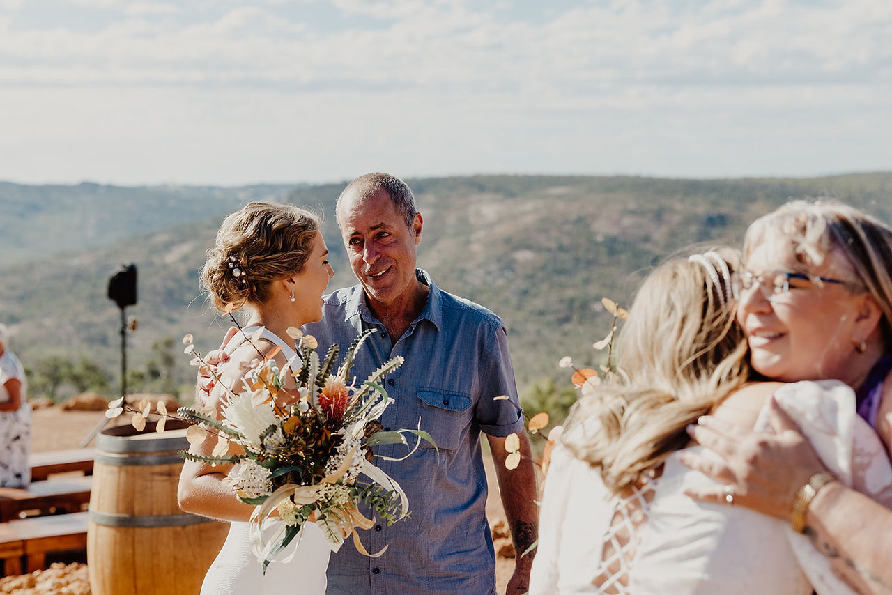 Parents and family hug the brides after their wedding ceremony at Anderson Point in the Perth HIlls