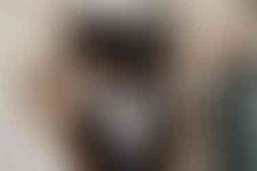 Outside North Perth Town Hall the bride and groom high five their guests as they exit the wedding ceremony