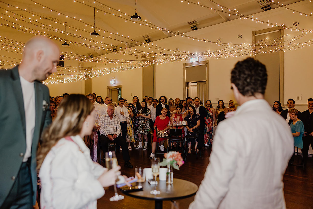 The bride and groom cut their wedding cake with a sword at North Perth Town Hall
