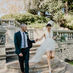 A bride and groom hold hands while walking down the stairs at Cottesloe Civic Centre