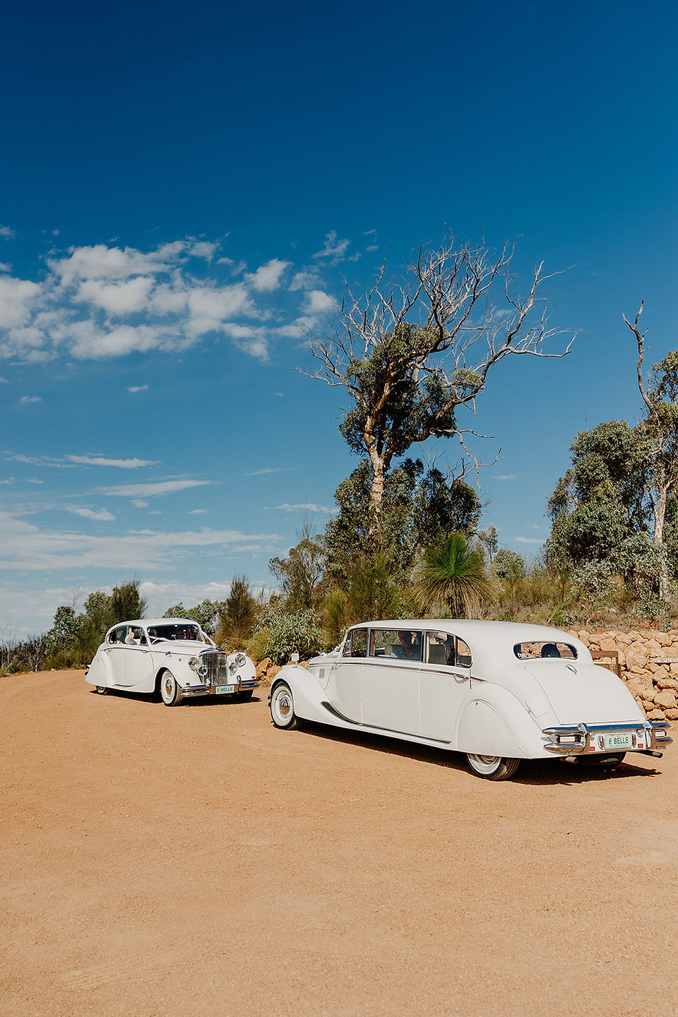 Two classic limosuines arrive at Anderson Point in the Perth hills carrying a bride each ready for their wedding ceremony