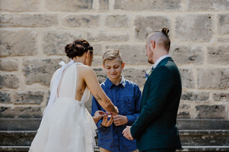 A child ringbearer hands over the wedding rings at the Secret Garden a Cottesloe Civic Centre