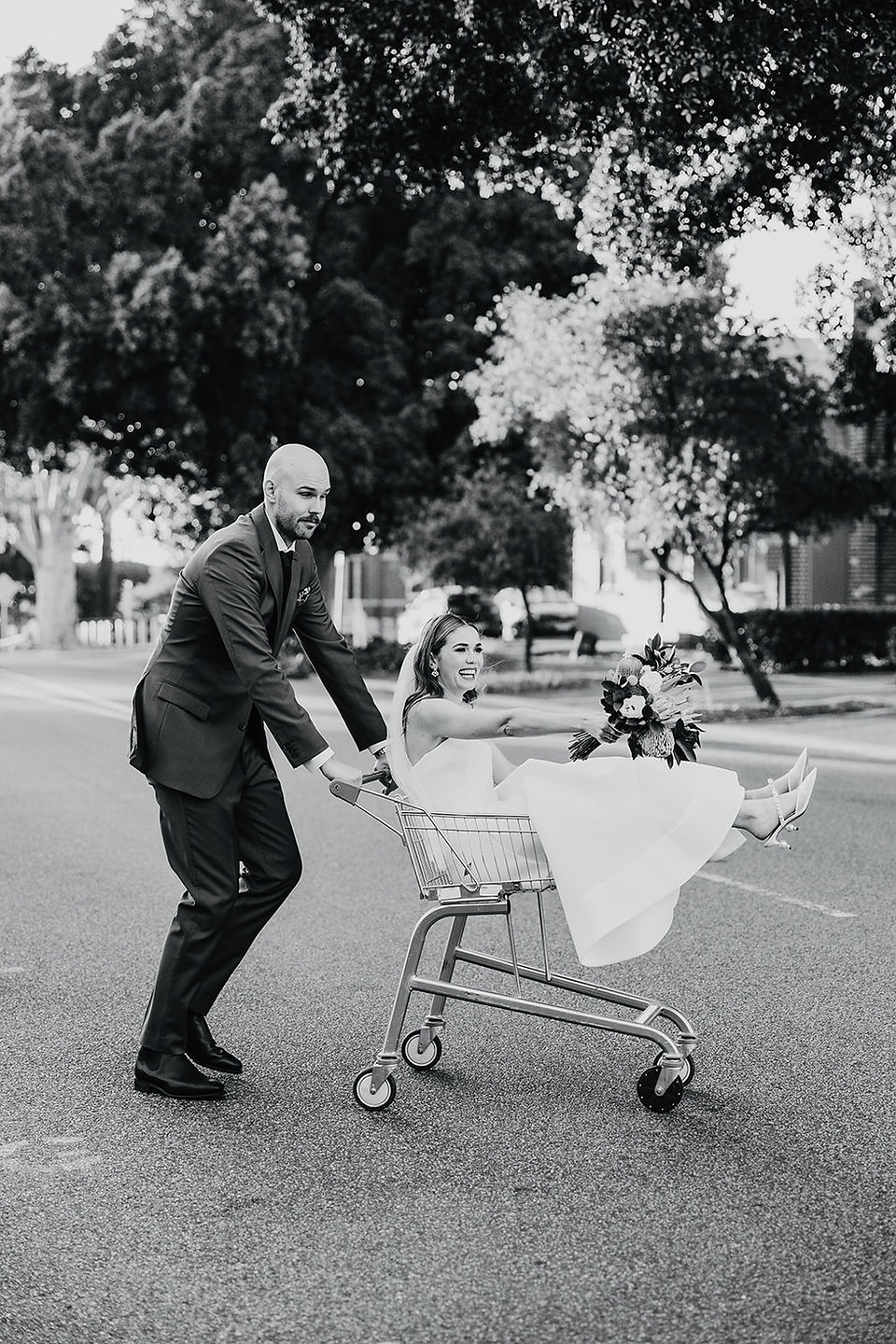 Relaxed and fun wedding portraits around North Perth Town Hall, including putting the bride in a trolley