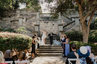 The bride and groom take a bow on the steps of the Secret Garden a Cottesloe Civic Centre at the conclusion of their wedding ceremony