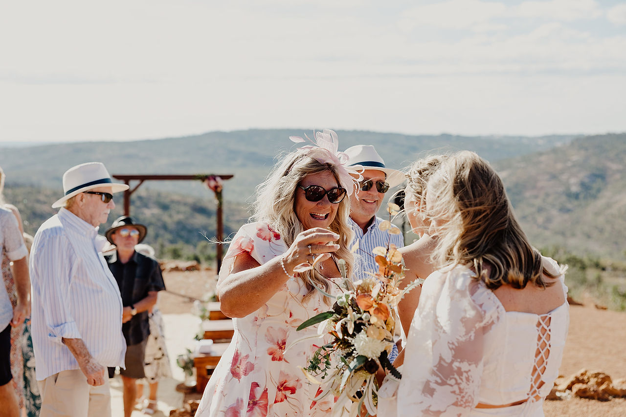 Parents and family hug the brides after their wedding ceremony at Anderson Point in the Perth HIlls