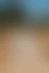 The two brides both wearing white dresses and holding flowers walk down the aisle at Anderson Point in the Perth Hills