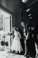 The bride and groom open the door to great guests arriving