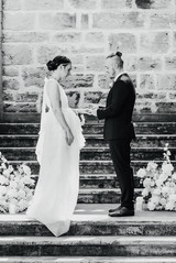 Ring exchange during the wedding ceremony on the steps at Secret Garden a Cottesloe Civic Centre