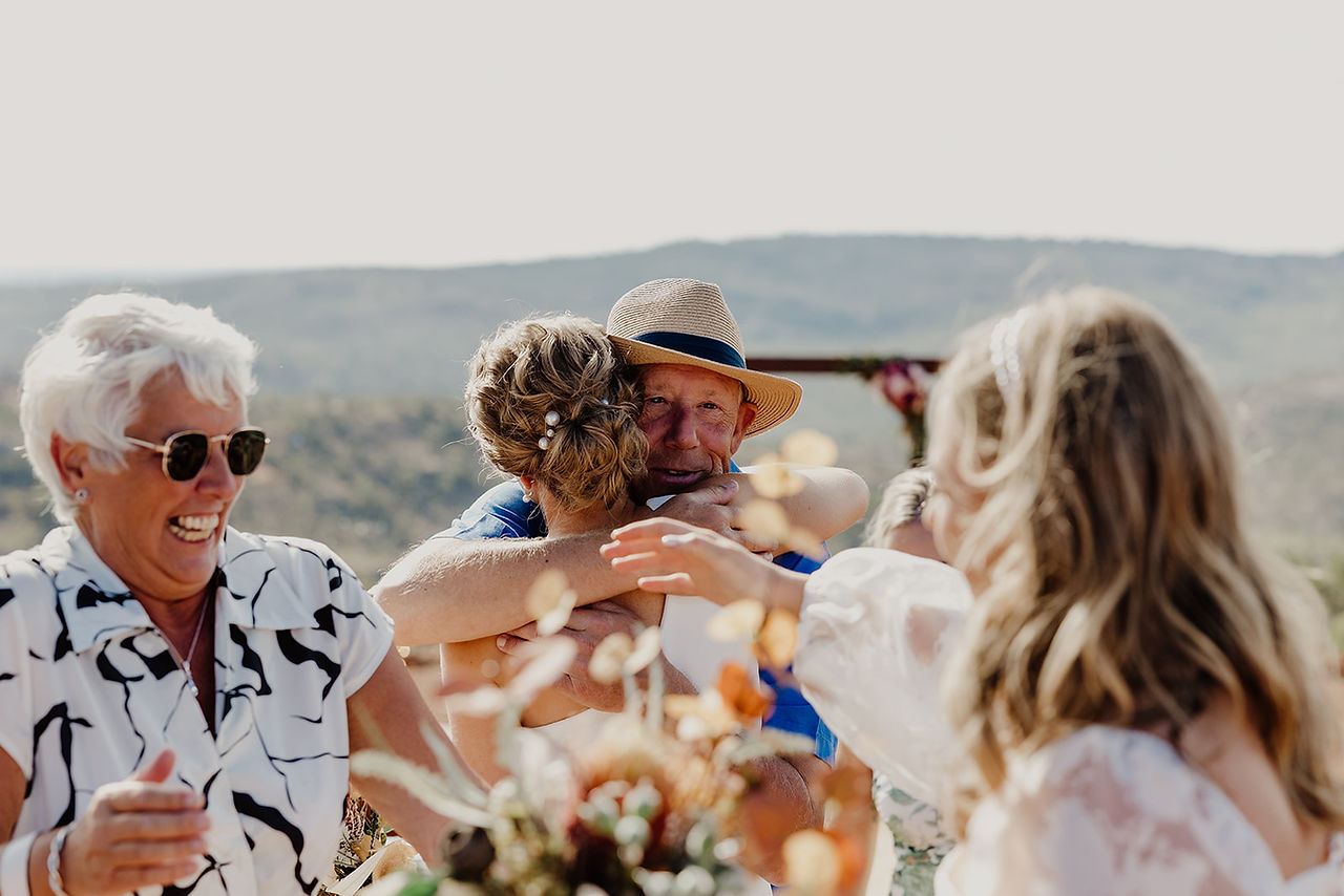 Parents and family hug the brides after their wedding ceremony at Anderson Point in the Perth HIlls