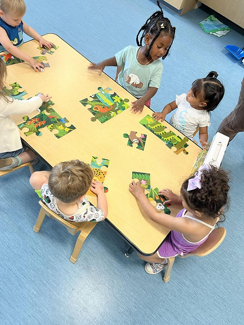 A group of kids at a table duringPuzzleTime