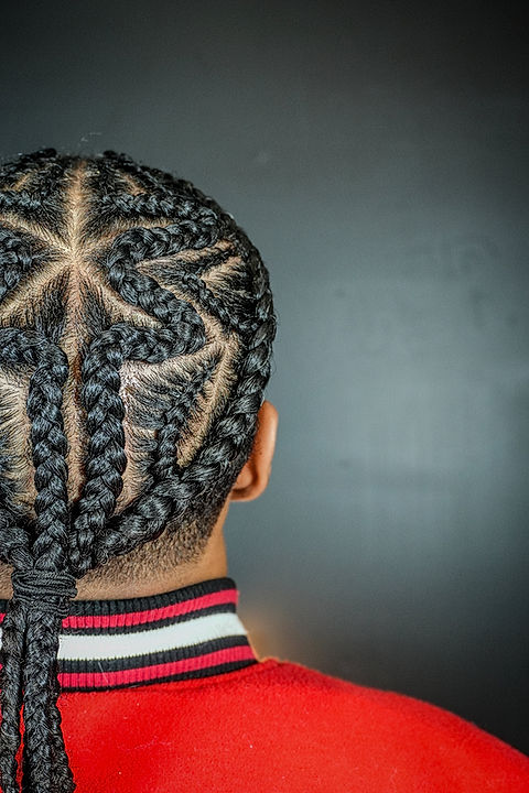 Stylist blow-drying and styling Black hair at a Toronto salon.