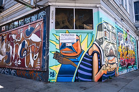 corner shot of a shop covered in mural art on all sides