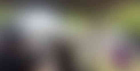 behind the bar facing the cocktail tables