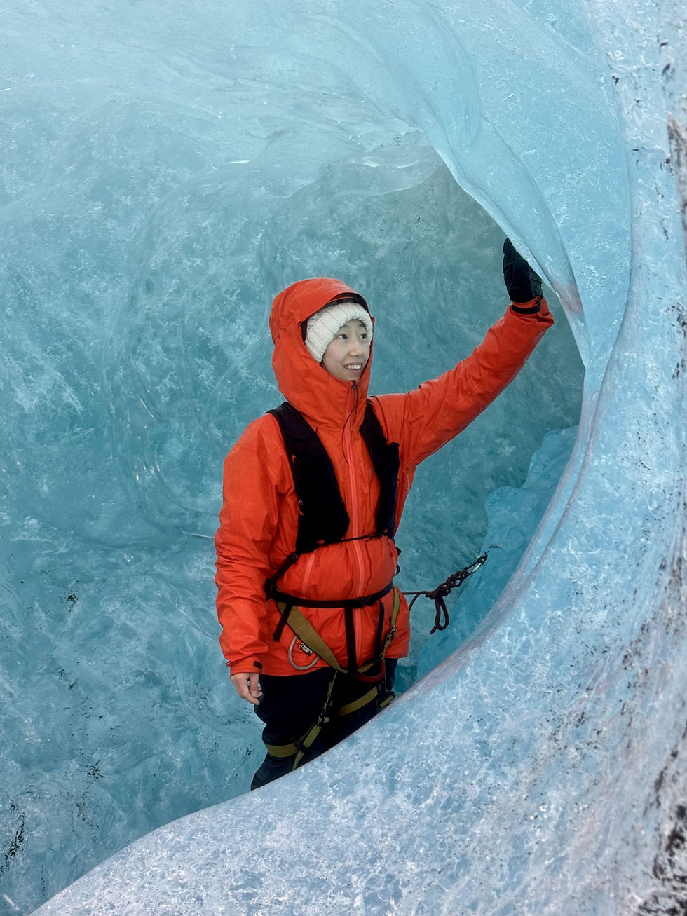 Curved tunnel of clear blue glacier ice inside a natural ice cave in Vatnajökull, Iceland