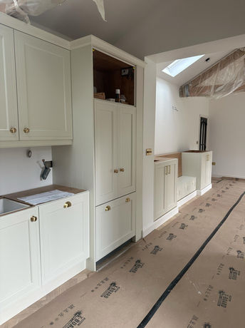 Open-plan kitchen and living area created during a garage conversion in Bowdon, featuring bespoke kitchen cabinetry and a cohesive interior design.