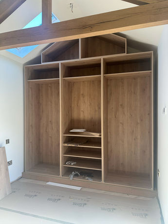 Bespoke fitted wardrobe storage designed around the bedroom space, providing practical organisation within a tailored interior.