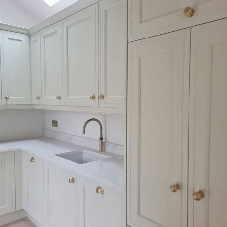 Utility room sink and fitted cabinetry designed by Stag Kitchens as part of a complete garage conversion and home renovation in Bowdon.
