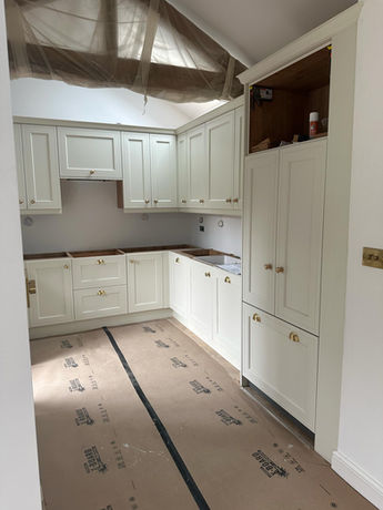 Open-plan kitchen and living area created during a garage conversion in Bowdon, featuring bespoke kitchen cabinetry and a cohesive interior design.