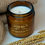 Thumbnail: Wrapped In You Valentine's Collection candle, gold logo, wheat and fabric background.