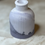 Thumbnail: Decorative vase with ribbed design and marbled detailing, on textured surface.
