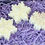 Thumbnail: Three snowflake-shaped soaps on purple shredded paper for decoration and gifting.