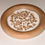 Thumbnail: White substance with brown pieces in a low bowl on white background.