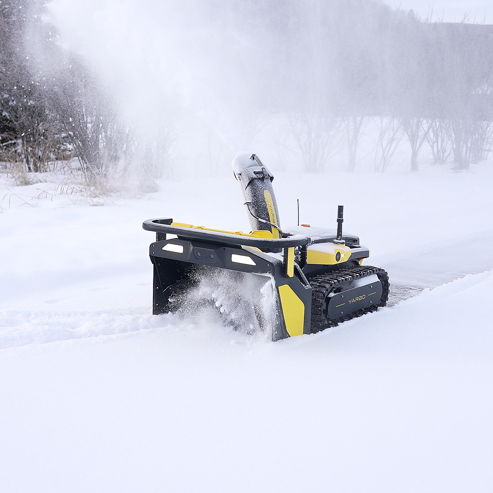 The Yarbo snowblower efficiently clears a path through deep snow, showcasing its powerful performance in a winter landscape.