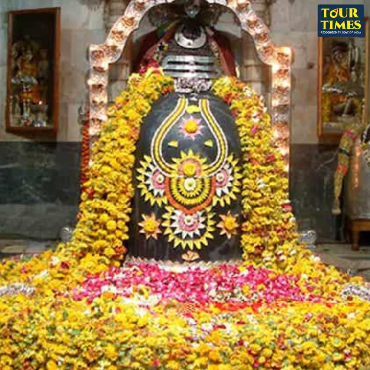 Floral-decorated Shiva lingam in a temple adorned with yellow and pink flowers, creating a sacred, vibrant atmosphere. Tour Times text visible.Ramanathaswamy Temple