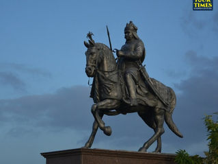 Bronze equestrian statue of a warrior on horseback against a blue dusk sky, with Tour Times watermark. Most Visited Places in Rajasthan
