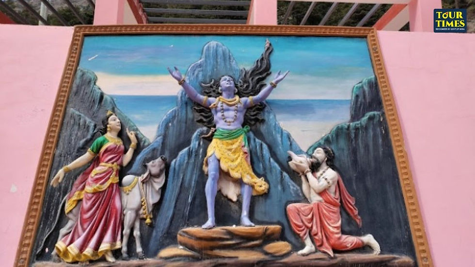 A relief sculpture shows a central figure with arms raised, flanked by two people and a cow. A mountain and sky form the background. Gangotri Temple