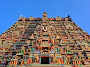 Colorful temple tower with intricate carvings under a clear blue sky. "TOUR TIMES" logo in the top-right corner.Temples in Tamil Nadu